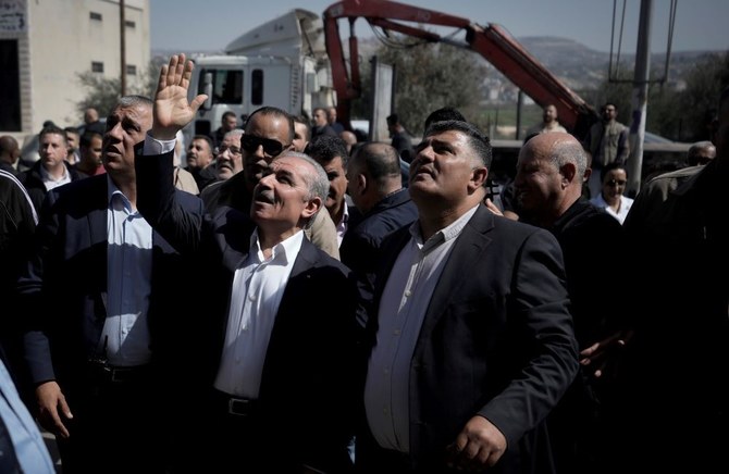 Palestinian PM Mohammad Shtayyeh surveys the damage after a rampage by settlers in Huwara, near the West Bank city of Nablus, Wednesday, March 1, 2023. (AP Photo)