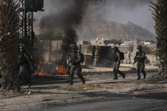 Israeli troops take up positions during clashes with Palestinians following a raid at the entrance to Aqabat Jaber refugee camp near the West Bank city of Jericho on March 1, 2023. (AP)