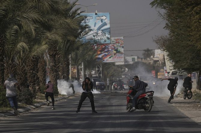 Palestinians clash with Israeli forces following a raid at the entrance to Aqabat Jaber refugee camp near the West Bank city of Jericho on March 1, 2023. (AP)