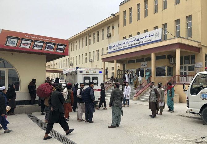 Thursday’s attack in the city of Mazar-e-Sharif killed three people, including governor Daud Muzmal, and injured four others. Above, people stand outside a hospital where some of those injured were taken after the blast. (AP)