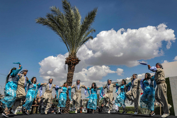 Members of an Iraqi Kurdish dance group perform during a commemoration in Arbil on March 11, 2023marking the 32nd anniversary of an uprising against the regime of toppled dictator Saddam Hussein. ()AFP)