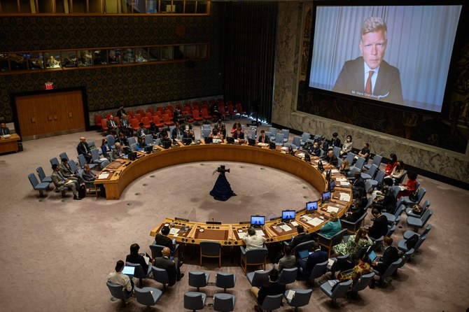 United Nations special envoy for Yemen Hans Grundberg (R) is displayed on a screen as he attends remotely a Security Council meeting. (File/AFP)
