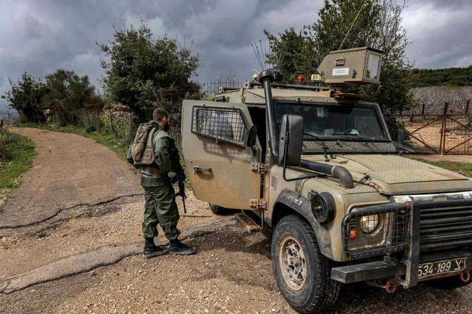 Israeli soldiers patrol along the border with Lebanon near the northern Arab-Israeli village of Arab Al-Aramshe on Mar. 15, 2023. (AFP)