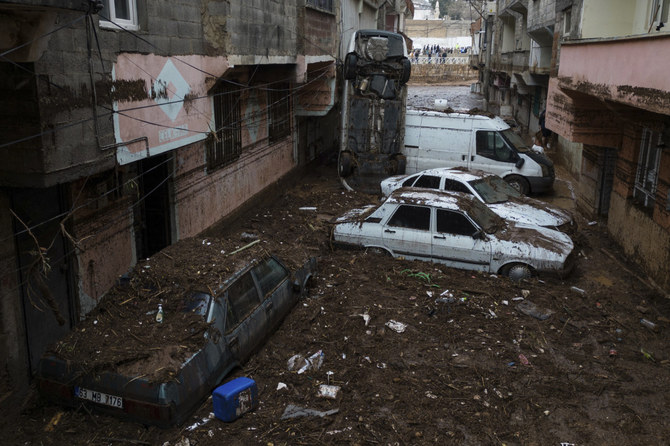 Vehicles are scattered during floods after heavy rains in Sanliurfa, Turkey, on March 16, 2023. (Hakan Akgun/DIA via AP)