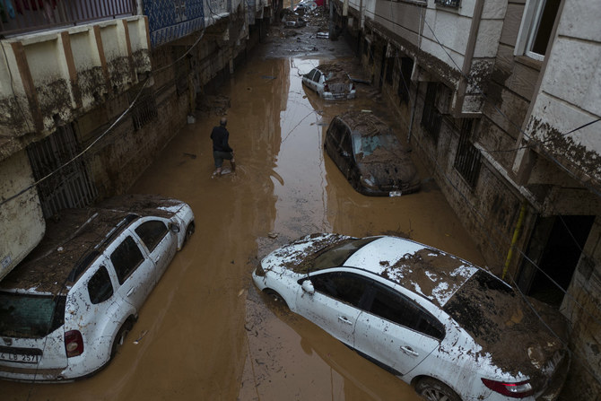 Vehicles are scattered during floods after heavy rains in Sanliurfa, Turkey, on March 16, 2023. (Hakan Akgun/DIA via AP)