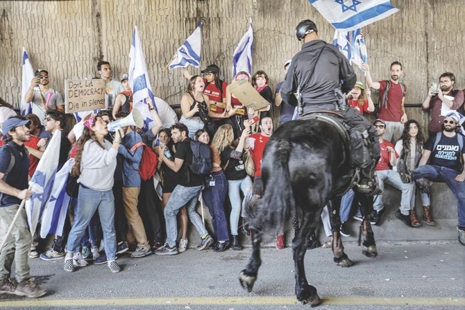 Israeli mounted police confront demonstrators in Tel Aviv on Thursday during a protest against the government’s controversial judicial reform bill. (AFP)