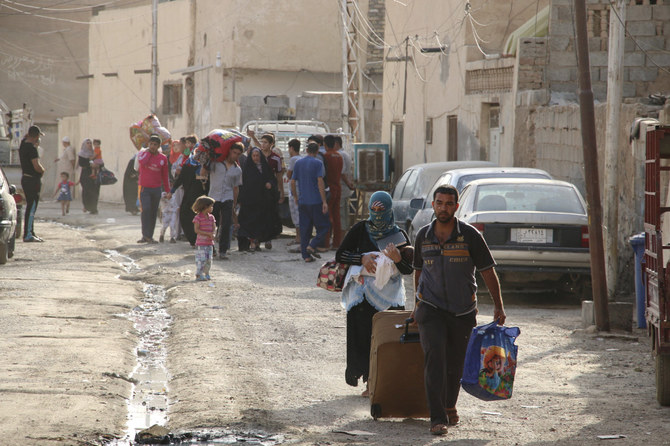Iraqis fleeing violence walk down a road in the city of Ramadi on May 15, 2015 as Daesh overrun most of the western provincial capital. (Reuters file)