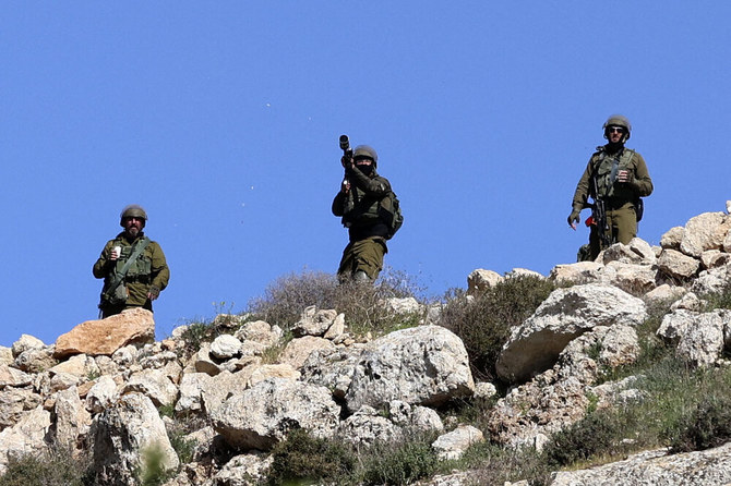 Israeli soldiers fire tear gas canister toward Palestinian demonstrators during clashes following a protest against the expansion of Jewish settlements, on Mar. 17, 2023, in the West Bank village of Beit Dajan. (AFP)