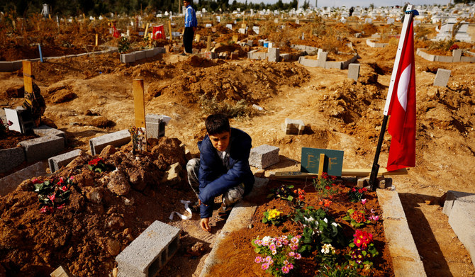 Salih Dogru, 12, and his cousin Eren Dogru, 14, visit earthquake victims’ graves at Cankaya cemetery, where they moved to in the aftermath of the Feb. 6 temblor that hit Syria and Turkiye. (AFP)