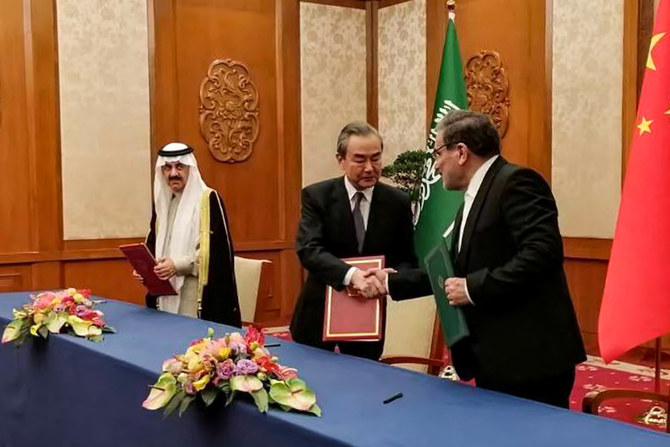 Secretary of the Supreme National Security Council of Iran Ali Shamkhani (R) shaking hands with the Director of the Office of the Central Foreign Affairs Commission of the Chinese Communist Party (CCP) Wang Yi (C) during a meeting with Saudi Arabia's National Security adviser and Minister of State Musaad bin Mohammed al-Aiban (L) in Beijing. (AFP)
