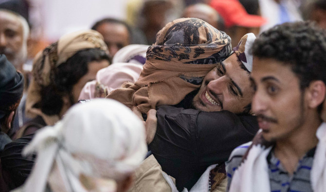 Yemenis greet their freed relatives during a prisoner exchange ceremony between the Houthis and government forces in Taiz. (AFP/File)