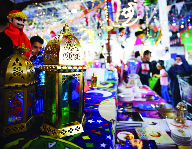 Ramadan is a time of celebration, as evidenced by the colorful decorations (right) in many places. (Abdullah Al-Faleh, AFP)