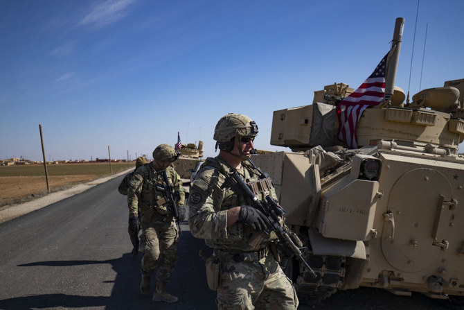 US troops patrol in the countryside of Syria's Hasakeh province near the Turkish border, on February 18, 2023. (Delil Souleiman / AFP)