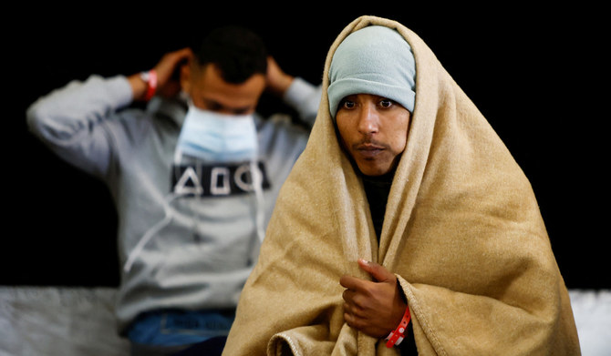 Migrants stand on the Geo Barents rescue ship, operated by Medecins Sans Frontieres (Doctors Without Borders), after being rescued from a wooden boat off the coast of Libya in the central Mediterranean Sea, March 24, 2023. (REUTERS)