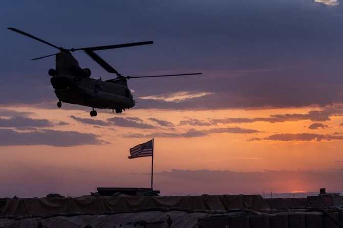 A U.S. Army CH-47 Chinook helicopter takes off at sunset while transporting American troops out of a remote combat outpost in northeastern Syria.(AFP)