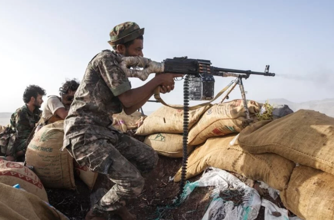 A Yemeni fighter backed by Coalition to Restore Legitimacy in Yemen fires his weapon during clashes with Houthi rebels. (AP/File Photo)