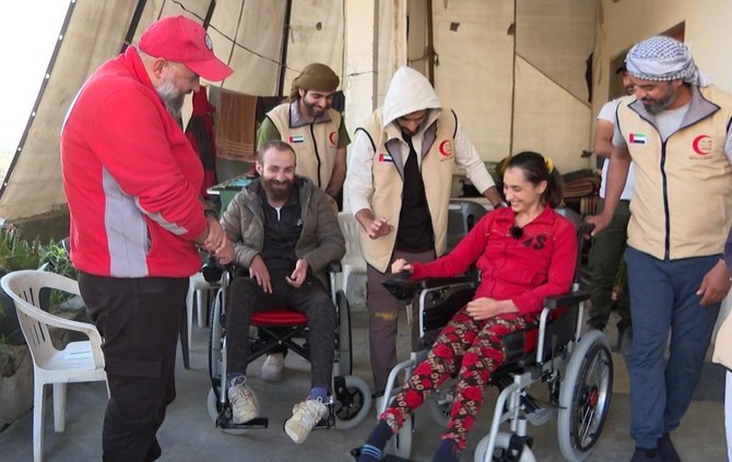 The Emirates Red Crescent field team with Syrian beneficiaries in the Latakia Governorate. (WAM)
