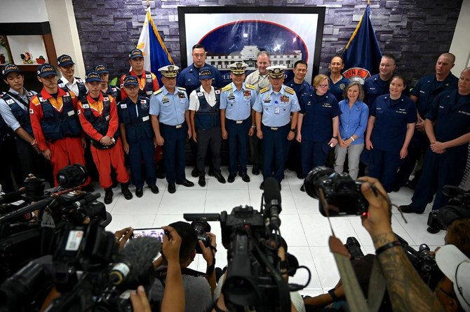 Members of the Japan Coast Guard Disaster Relief Team, Philippine Coast Guard officials and members of the US Coast Guard Oil Spill Response Team pose for a photo during a courtesy call at the Philippine Coast Guard National Headquarters in response to a request for assistance from the Philippine Coast Guard with the cleanup of an oil spill, in Manila on March 20, 2023. (AFP)