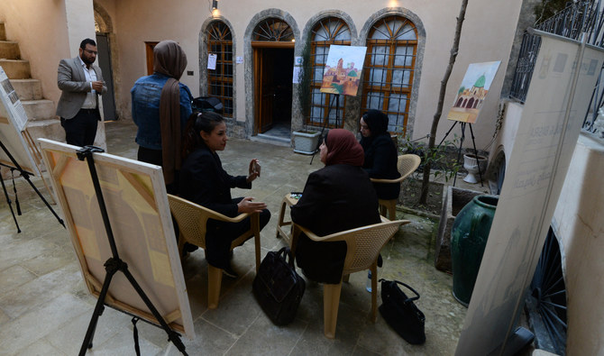 Iraqis who volunteered to share their memories of what they endured under Daesh group, gather with members of the Mosul Eye project, before being interviewed in Mosul, on February 27, 2023. (AFP)