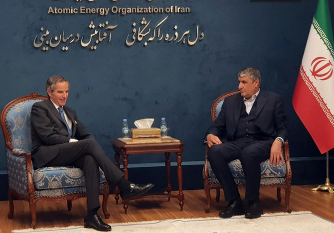 A handout picture provided by Iran's Atomic Energy Organisation shows Head of Iran Atomic Energy Organization Mohammad Eslami (R) meeting with International Atomic Energy Agency head Rafael Grossi (L) at the Mehr Abad airport in Tehran. (AFP PHOTO / Atomic Energy Organization of Iran)