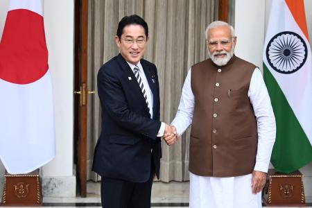 Japan's Prime Minister Fumio Kishida (left) shakes hands with his Indian counterpart Narendra Modi before their meeting at the Hyderabad House in New Delhi on March 20, 2023. (AFP)