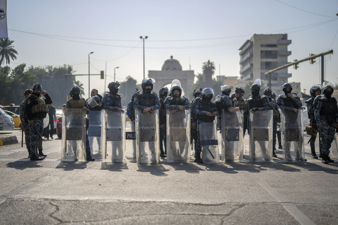 Riot police take position in in Baghdad as pensioners demonstrate on Feb. 27, 2023. (AP)