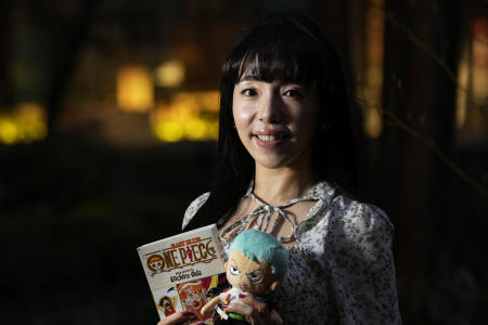 Nina Oiki, a gender and politics researcher at Tokyo's Waseda University, poses for a photo with some of her favorite 