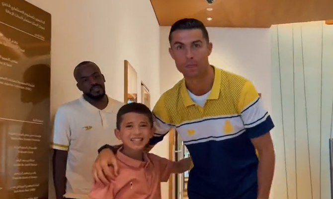 Screengrab shows Al-Nassr’s Portuguese superstar Cristiano Ronaldo with earthquake-survivor Rabea Shaheen, 10-year-old Syrian boy, whose dream was to meet and watch the football legend, taken from a video posted by GEA’s chairman Turki AlSheikh. (Twitter/ @Turki_alalshikh)