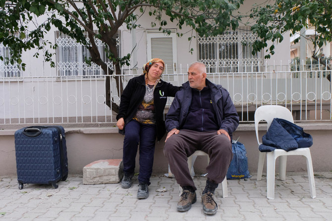 Survivors Reyhan Vural and her husband Metin sit on plastic chairs facing the rubble of their home in the aftermath of a deadly earthquake in Osmaniye, Turkiye Feb. 27, 2023. (Reuters)