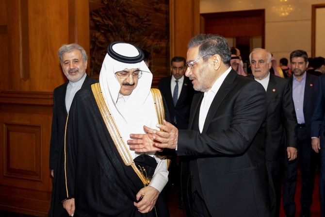 Saudi Arabia’s Musaad bin Mohammed Al-Aiban with Iran’s Ali Shamkhani in Beijing on Friday. (Reuters)