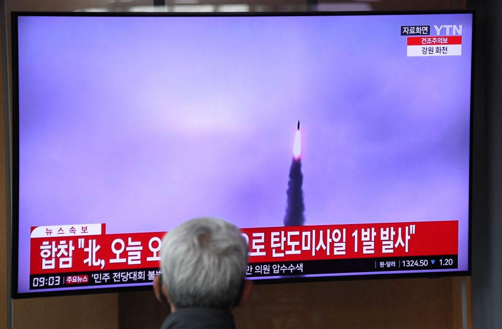 A man watches a television screen showing a news broadcast with file footage of a North Korean missile test, at a railway station in Seoul, April. 13, 2023. (AFP)