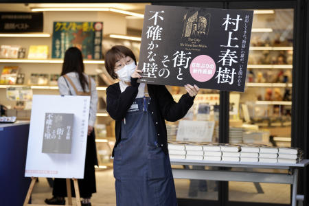 A shop clerk advertises Japanese writer Haruki Murakami's new novel 