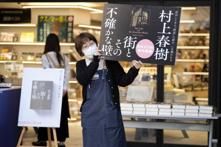 A shop clerk advertises Japanese writer Haruki Murakami's new novel