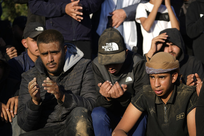 Mourners pray at the grave of Mohammed Al-Osaibi, 26, who was killed by Israeli police in Jerusalem's Old City, at his funeral in Hura, a Bedouin Arab village in southern Israel, Sunday, April 2, 2023. (AP)