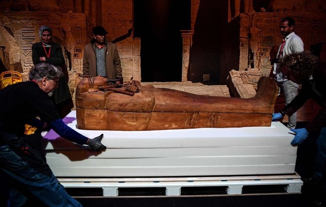 Workers unveil the coffin of King Ramses II during a ceremony ahead of the opening of the exhibition ‘Ramses et l’or des pharaons’ at the Grande Halle de la Villette in Paris on April 3, 2023. (AFP)
