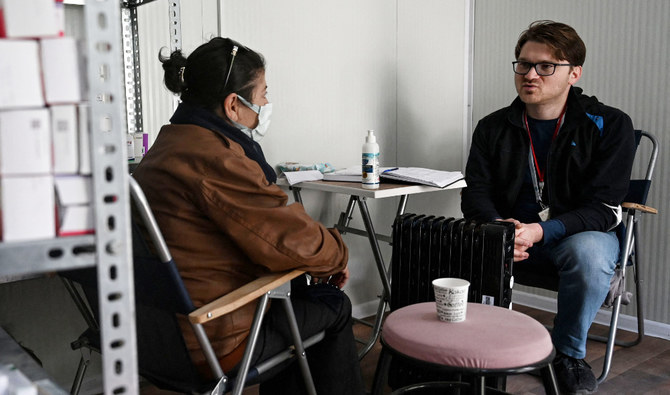 Eralp Turk — a volunteer psychiatrist — speaks during a consultation with a patient, in Antakya, Turkiye. (AFP)