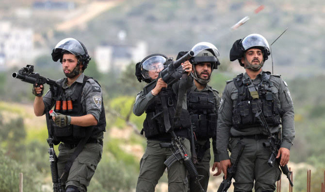 Israeli security forces fire tear gas at Palestinians. (AFP)