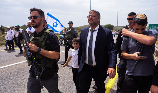 Israeli Security Minister Itamar Ben-Gvir joins Israeli settlers as they hold a protest march from Tapuach Junction to the Israeli settler outpost of Avitar, in the Israeli-occupied West Bank, April 10, 2023. (Reuters)