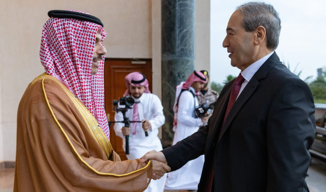 Saudi FM Prince Faisal bin Farhan, left, welcomes visiting Syrian FM Faisal Al-Miqdad in Jeddah on Wednesday. (SPA)