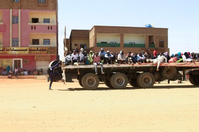 People fleeing street battle between the forces of two rival Sudanese generals, are transported on the back of a truck in the southern part of Khartoum, on April 21, 2023. (AFP)