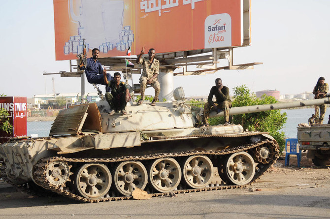 Sudanese army soldiers, loyal to Abdel Fattah Al-Burhan, sit atop a tank in the Red Sea city of Port Sudan as the African country’s crisis deepens by the day. (AFP)