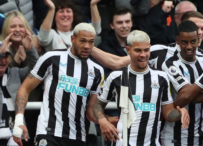 Joelinton, left, celebrates scoring Newcastle United’s second goal against Tottenham Hotspur with Bruno Guimaraes, center, and Alexander Isak, St. James’ Park, Newcastle, Britain, Apr. 23, 2023. (Reuters)
