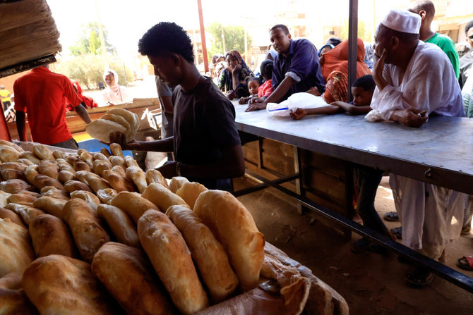 People gather to get bread during clashes between the paramilitary Rapid Support Forces and the army in Khartoum, Sudan, on April 22, 2023. (REUTERS)