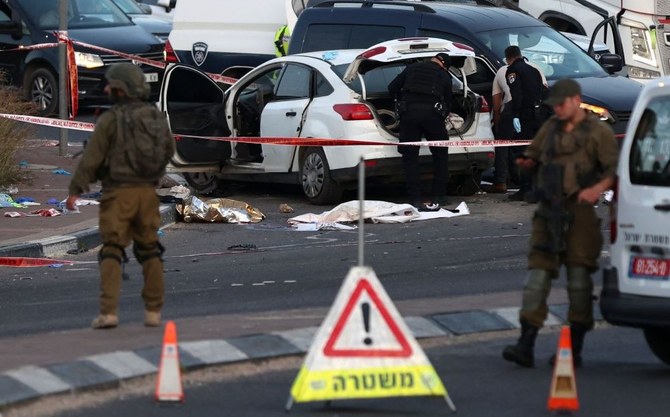Israeli soldiers inspect the site of an attempted car-ramming attack near the Gitai Avissar junction, near Salfit, in the occupied West Bank on April 27, 2023. (AFP)