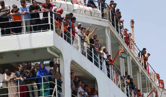 Evacuees stand on a ferry as it transports some 1900 people across the Red Sea from Port Sudan to the Saudi King Faisal navy base in Jeddah, on April 29, 2023, during mass evacuations from Sudan. (AFP)