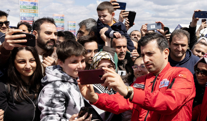 Selcuk Bayraktar, chairman of Turkish defense firm Baykar, takes a selfie with visitors at Teknofest airshow in Istanbul, Türkiye. (Reuters)
