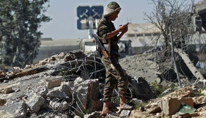 A Houthi militant looks at his phone, Sanaa, Yemen, Dec. 21 2021. (AFP)