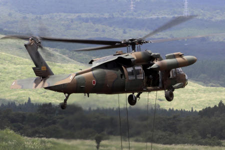 A helicopter is seen during an annual live firing exercise at Higashi Fuji range in Gotemba, on Aug. 25, 2016. A UH-60JA Black Hawk helicopter disappeared from radar on Thursday afternoon, April 6, 2023, while on a reconnaissance mission near Miyako island, the head of the Ground Self Defense Force, Yasunori Morishita, said at a news conference later that day. (AP)
