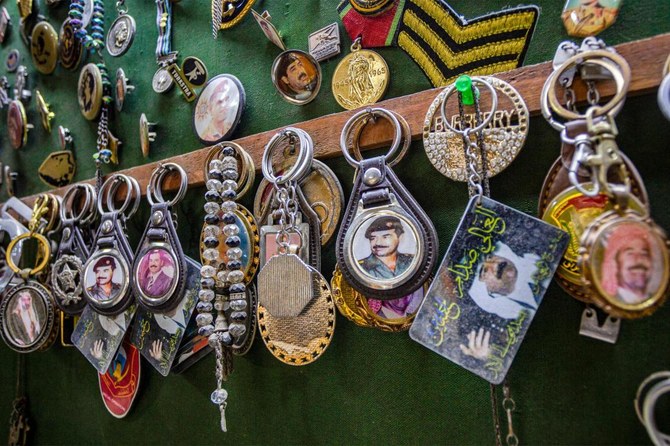 In this picture taken on March 31, 2023, keychains showing portraits of Iraq's late ousted dictator Saddam Hussein and the country's first modern monarch King Faisal I are displayed at an antique shop in Baghdad. (File/AFP)