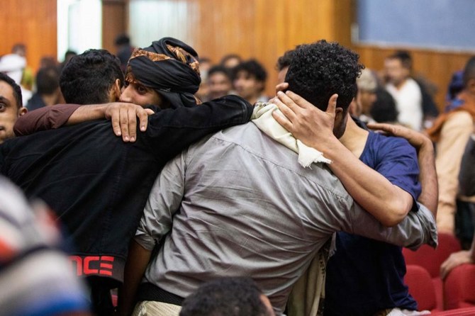 Yemenis greet their freed relatives during a prisoner exchange ceremony between the Houthis and the government. (File/AFP)